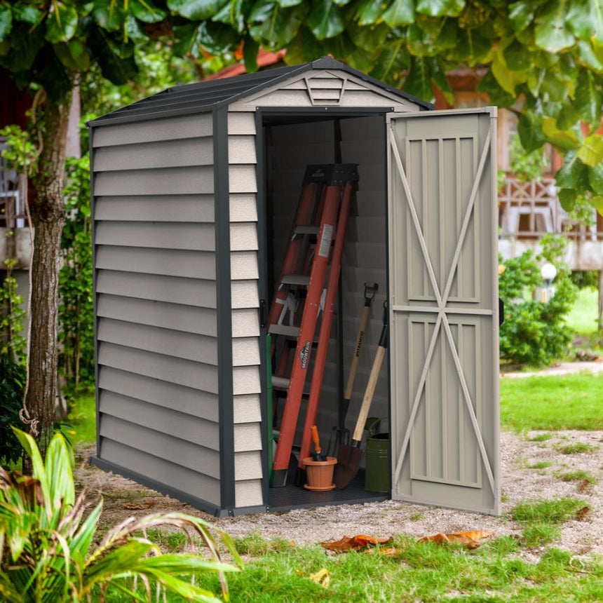 A grey Duramax Evermore plastic garden shed with a single door open, showing the interior with some tools. It is situated in a garden setting.
